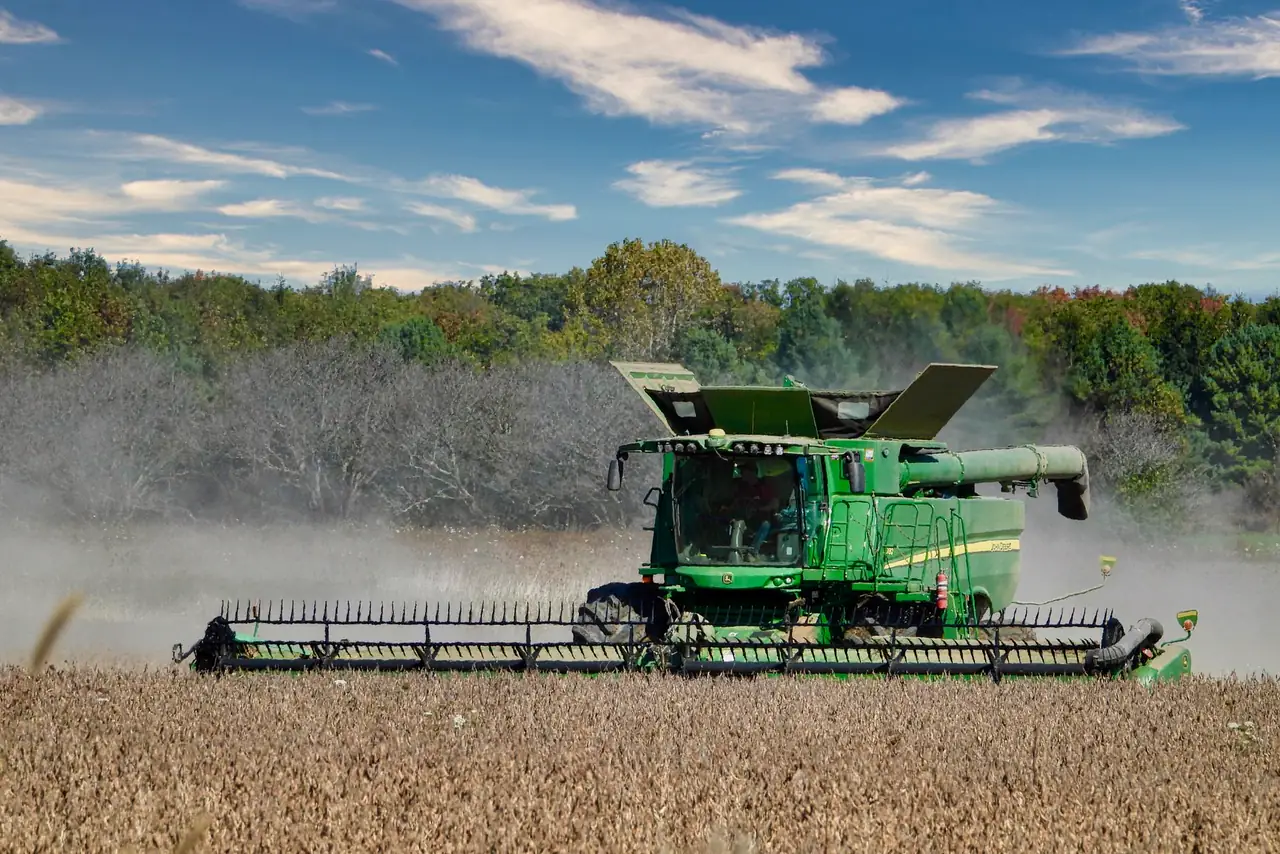 Green combine harvester works a soybean field in Ontario, Canada