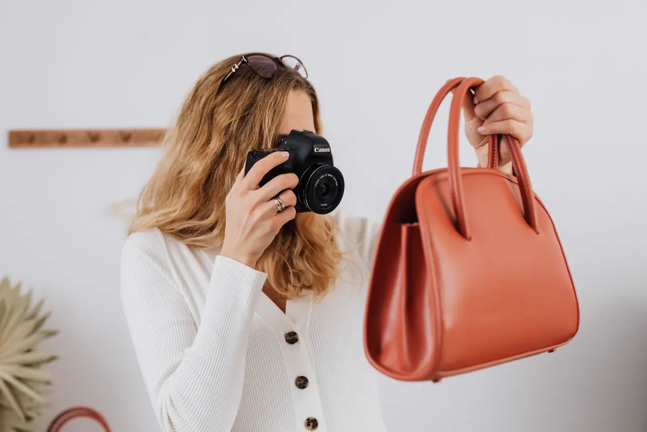 Seller photographs a handbag for her online shop listing