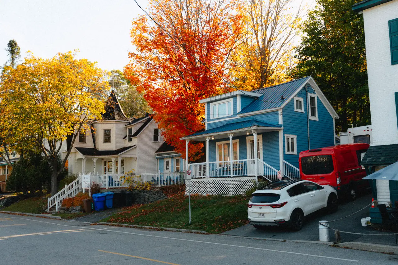 Colourful houses framed by bright autumn foliage in North Hatley, Quebec
